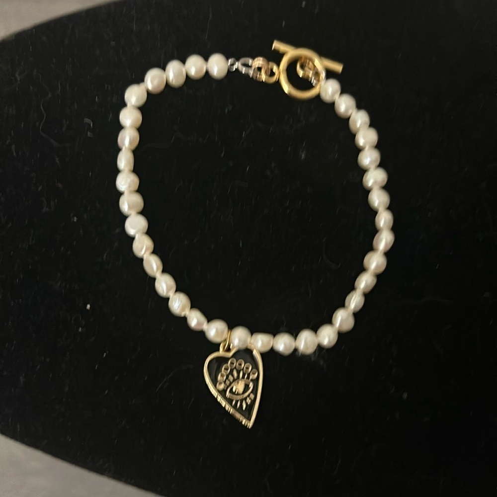 Beautiful pearl bracelet with evil eye heart drop